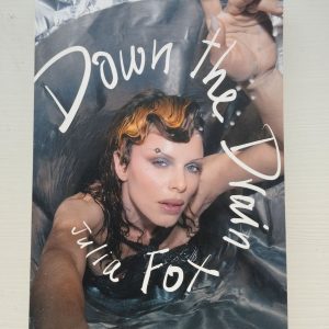 Book cover of Down the Drain by Julia Fox, showing the author in a metallic tub, reaching up with fierce expression—symbolizing the memoir’s bold, unfiltered tone.